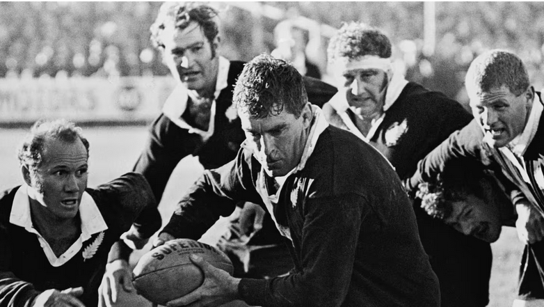 Colin Meads handling the rugby ball during a 1971 match.